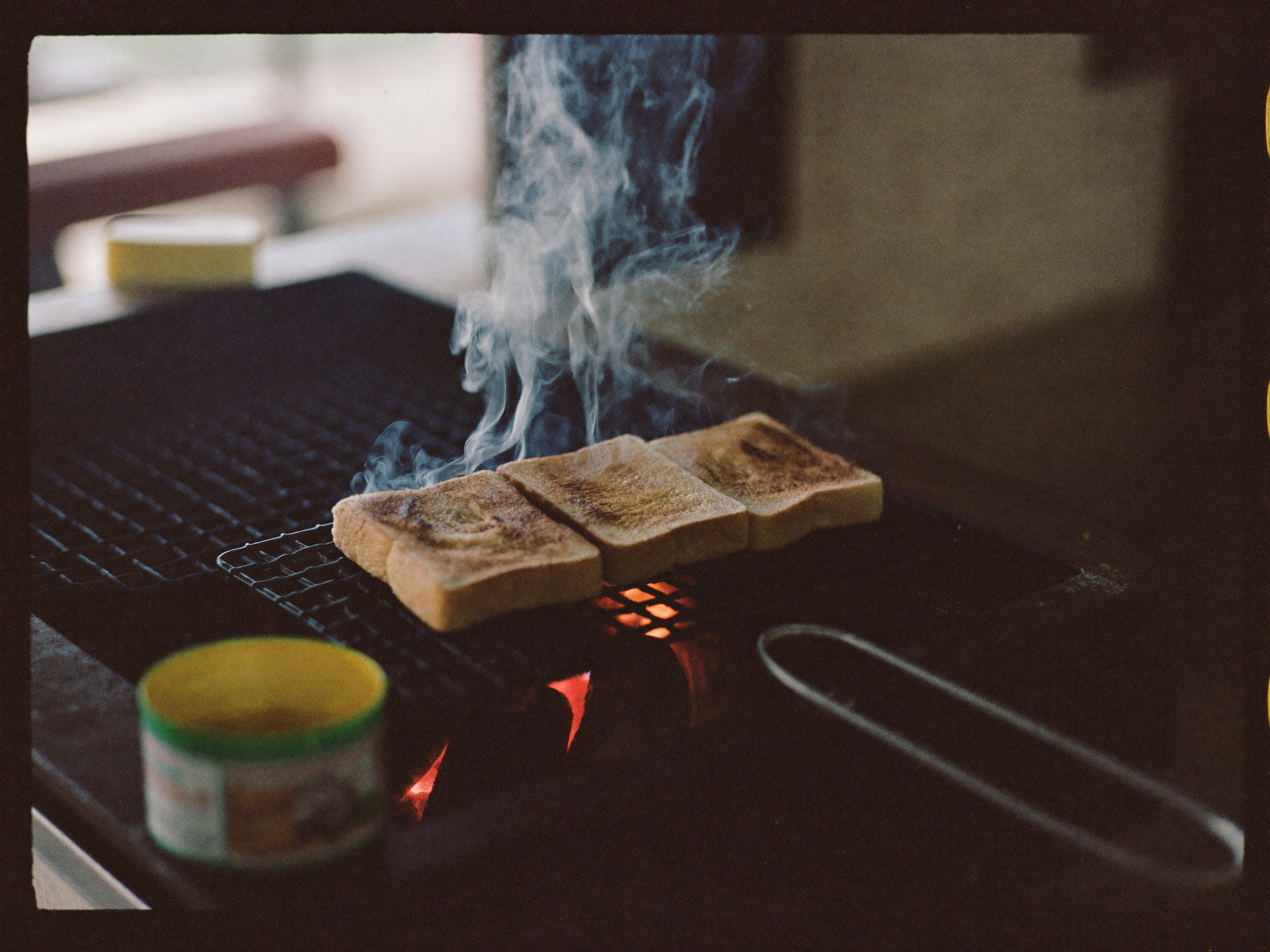 Kaya toast on the charcoal grill during busy service